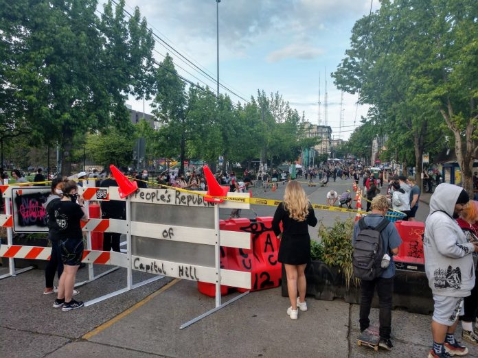 People look on a cordoned off Pine Street just before protesters add 