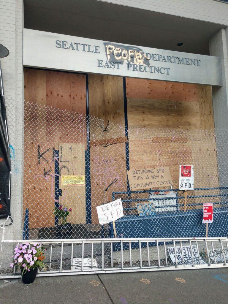 Sign outside Seattle People's Department reads "Defunding SPD: This is now a community center." (Photo by Doug Trumm)