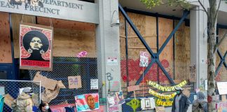 The memorials along the East Precinct police station--now christened the Capitol Hill Community Center--keep growing. (Photo by Doug Trumm)