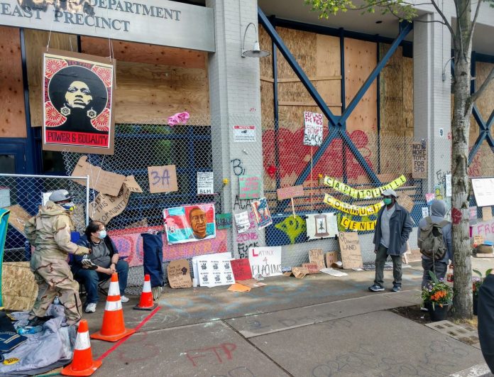 The memorials along the East Precinct police station--now christened the Capitol Hill Community Center--keep growing. (Photo by Doug Trumm)