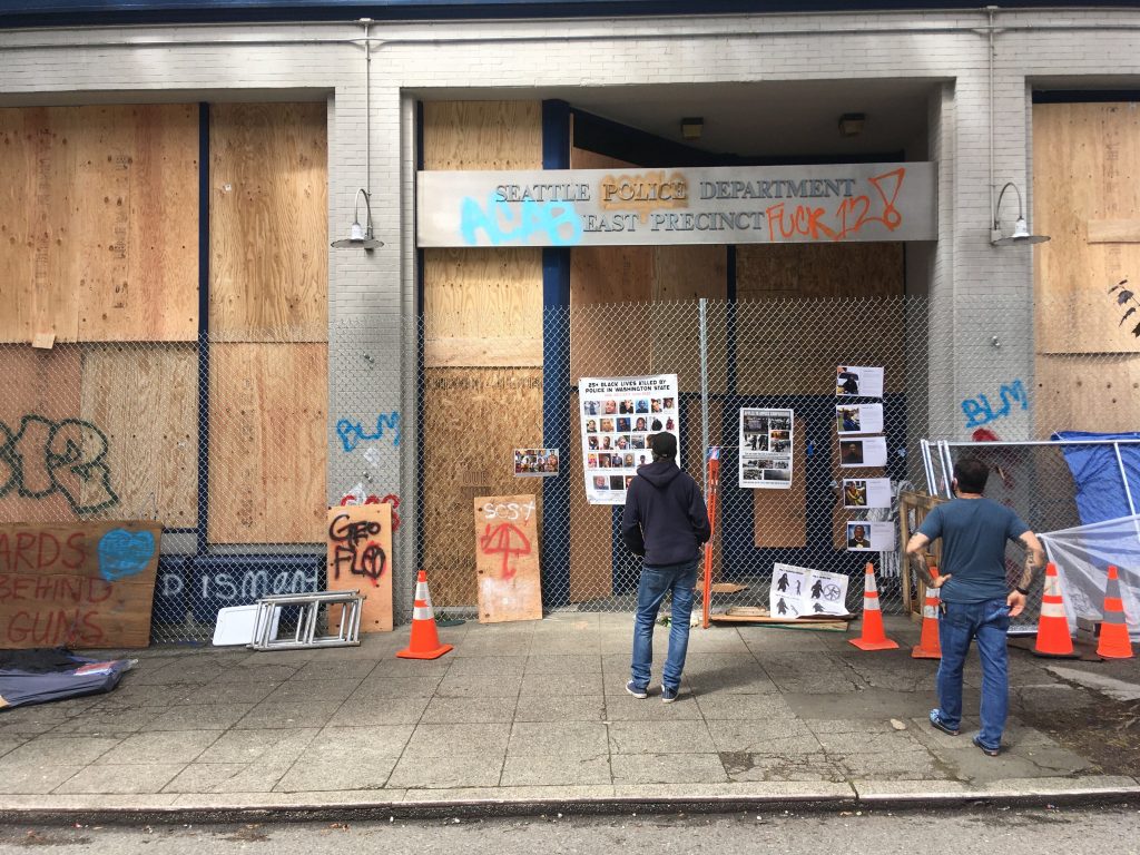The East Precinct is boarded up and protesters have added some edits to signage such as "Fuck 12". (Photo by Michael Goldman)