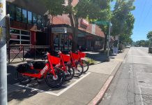 Lime Relaunches Bikeshare in Seattle with 500 Jump Bikes Lime-owned red Jump bikes in Ballard drop-off zone. (Courtesy of Lime)
