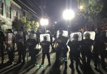 Council Stands with Protesters as Police Turn Violent Again in Day 9 A wall of police with riot shields outside East Precinct.