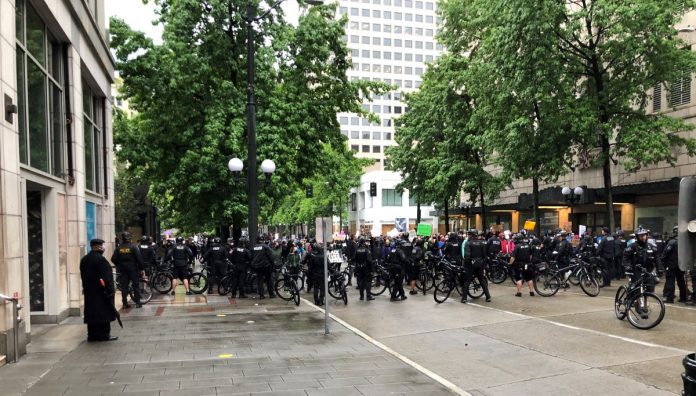A large contingent of police barricaded 4th Avenue with their bicycles, blocking a route out of Westlake Park. (Photo by Robert Cruikshank)