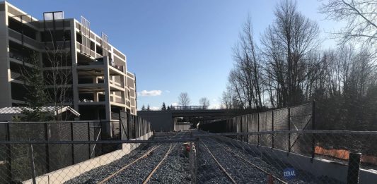 Light rail tracks near a Bellevue parking garage. Sound Transit's expansion timelines are under financial stress due to the Covid recession. (Photo by Stephen Fesler)
