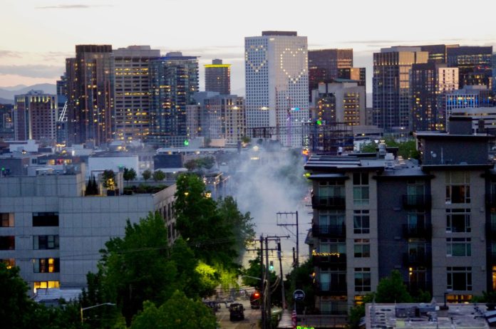 Tear gas rises near the East Precinct building on E. Pine St. on Monday, May 1, as police disperse a crowd of protestors. (Photo by Ethan Campbell)