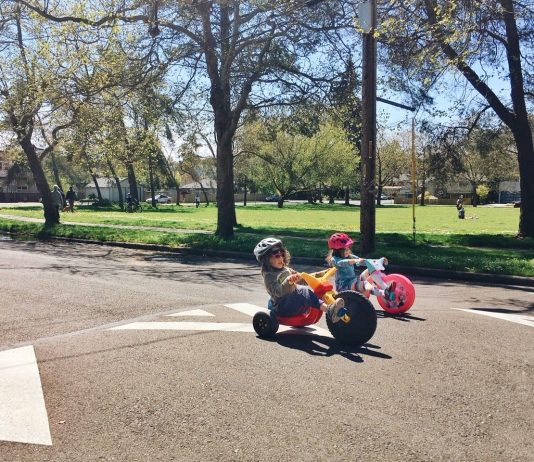 The Secret to Seattle’s Success is Social Infrastructure, not Low Taxes Two young kids on trikes in an open street.