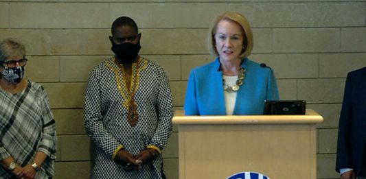 Mayor Jenny Durkan flanked by Andre Taylor at Monday press conference on the CHOP shooting. (Seattle Channel)
