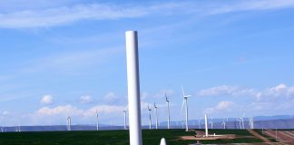 Wind turbines with one half-constructed turbine in the foreground.