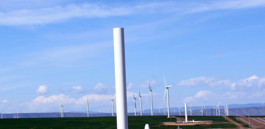 Wind turbines with one half-constructed turbine in the foreground.
