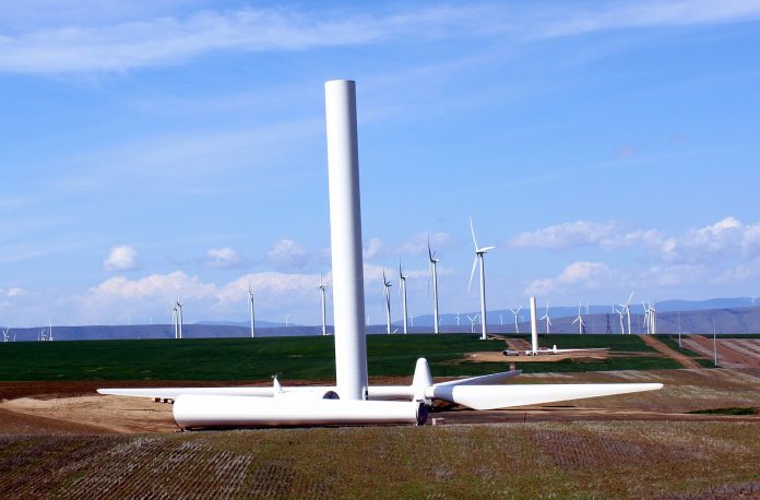 Wind turbines with one half-constructed turbine in the foreground.