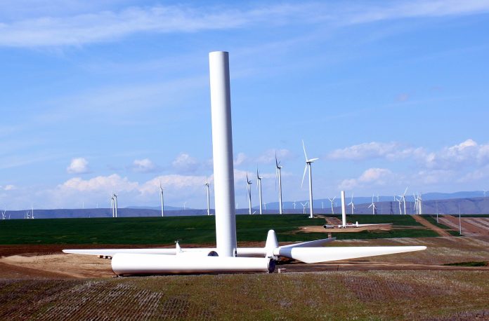 Wind turbines with one half-constructed turbine in the foreground.