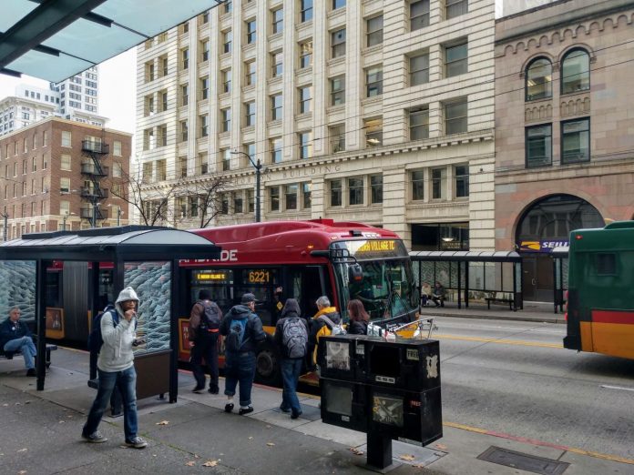 Riders board the RapidRide E, which gets a big boost from the STBD, on Third Avenue in Downtown Seattle. (Photo by Doug Trumm)