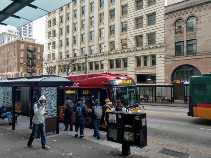 Third Avenue bus stop Riders board the RapidRide E, which gets a big boost from the STBD, on Third Avenue in Downtown Seattle. (Photo by Doug Trumm)