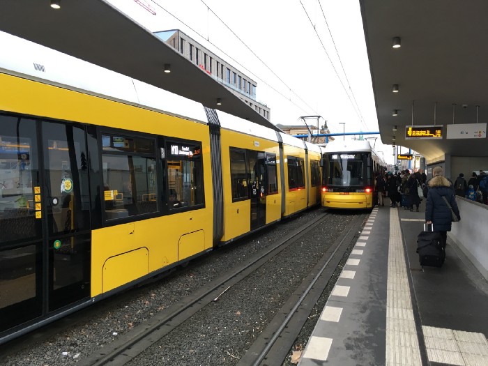 Yellow modern trams in a Berlin transit station.