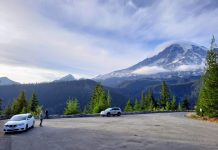 Mount Rainier National Park Seeks Input to Guide Access Upgrades Clouds crown Mount Rainier as a few cars stop for passengers to take in the view.