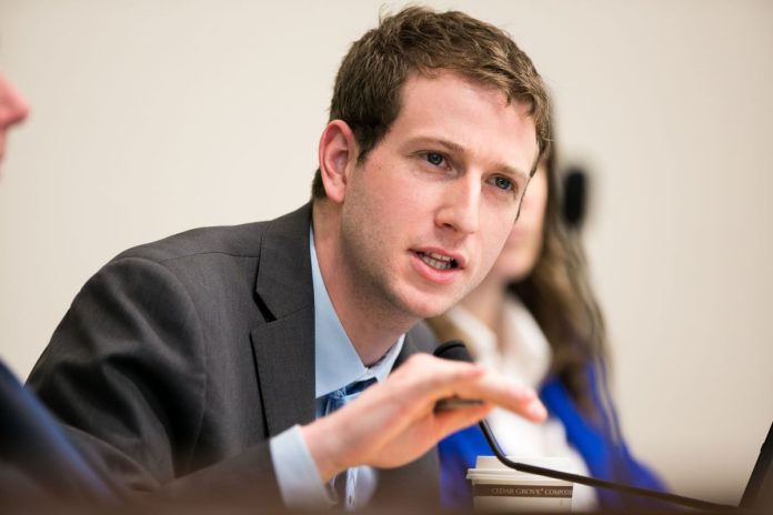 Picture of Joe Fitzgibbon making a hand gesture at a hearing. (Credit: Washington State Legislature)