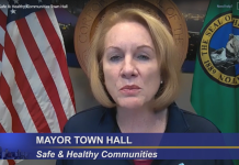 Durkan Vetoes $86 Million in Covid Relief Citing Fiscal Restraint Mayor Durkan flanked by the American flag and Washington state flag.