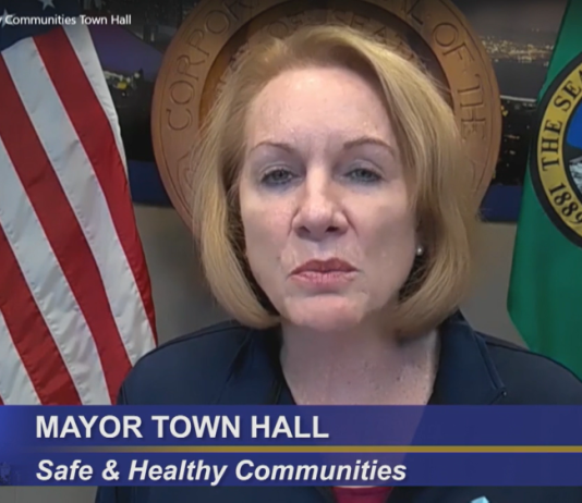 Durkan Vetoes $86 Million in Covid Relief Citing Fiscal Restraint Mayor Durkan flanked by the American flag and Washington state flag.