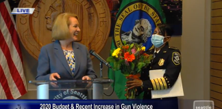 Mayor Jenny Durkan gave soon-to-retire Police Chief Carmen Best some flowers to express her gratitude during a press conference about blocking police budget cuts in the Norm Rice room at City Hall. (Seattle Channel)