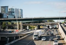 Bellevue’s New I-405 Interchange Won’t Reduce Congestion I-405 northbound car traffic with bridges and skyscrapers in the background.