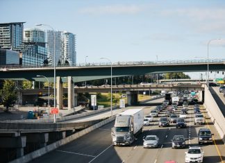 Bellevue’s New I-405 Interchange Won’t Reduce Congestion I-405 northbound car traffic with bridges and skyscrapers in the background.