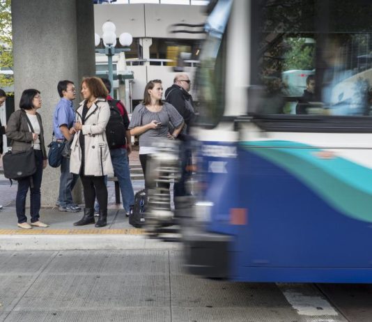 Sound Transit Fare Enforcement Reform Still Fraught, Pilot Coming Along With Fare Changes Seven passengers wait to board a Sound Transit bus. (Photo courtesy of Sound Transit)