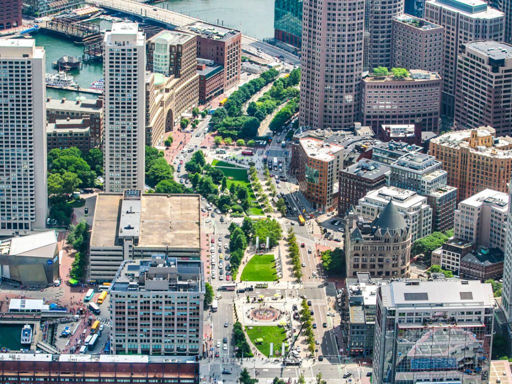 A linear park (with I-93 underneath) abuts several highrises in Boston.