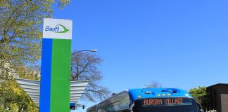 A Swift station with a bus waiting.