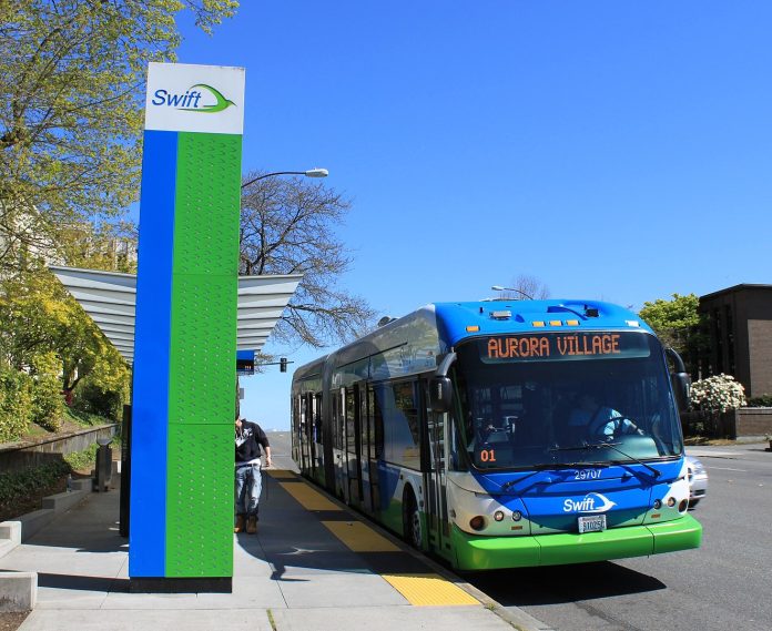 A Swift station with a bus waiting.