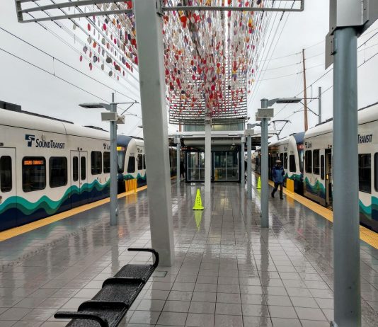 Sound Transit Prepares to Unpause Nine Project Actions and Moves to Surplus Angle Lake Properties two trains at a station with little glass orbs sculpture overhead
