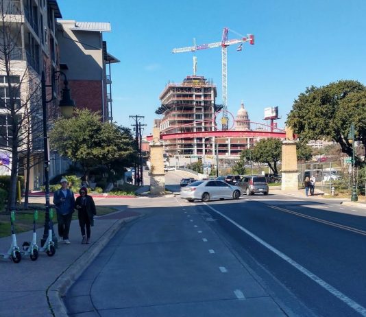 City Council Greenlights Scootershare Pilot, Pedersen Dissents Three scooters on a sidewalk in Austin, Texas.