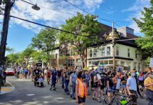 Dear Seattle City Council: Override Mayor Durkan’s Veto and Divest from Racist Policing Protesters marching on Ballard Avenue with signs