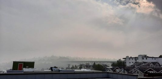 Fremont rooftops with a haze of smoke over and sun barely poking through.