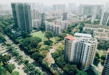 Every City Already Has Solutions for Climate Change Residential towers and tree-lined streets with haze on the horizon.