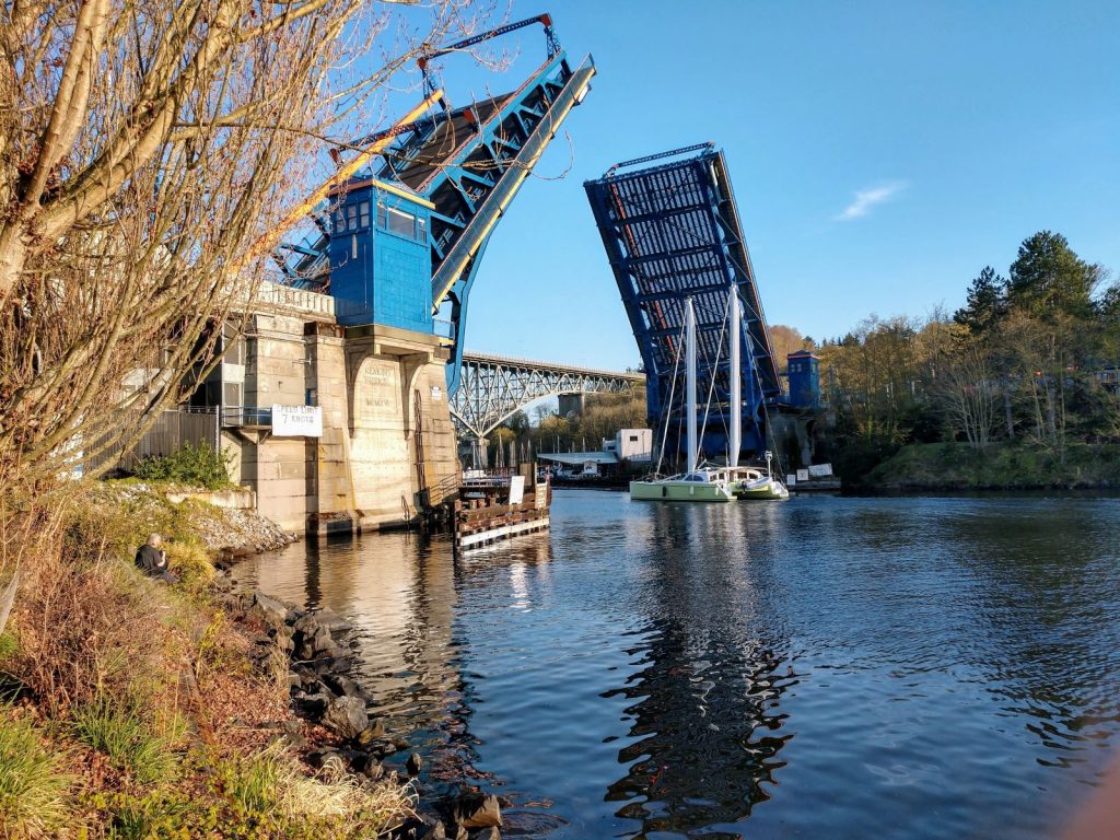 The Fremont Bridge goes up to let a catamaran pass.