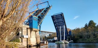 The Fremont Bridge goes up to let a catamaran pass.