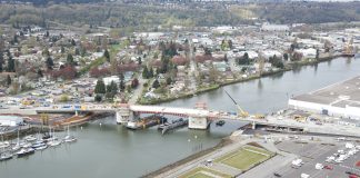 An aerial photo of the South Park Bridge under construction with the Duwamish Valley in the background.