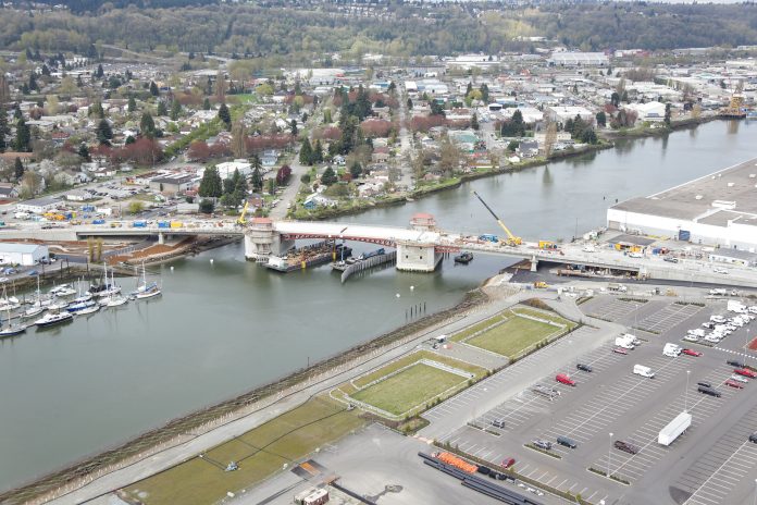 An aerial photo of the South Park Bridge under construction with the Duwamish Valley in the background.