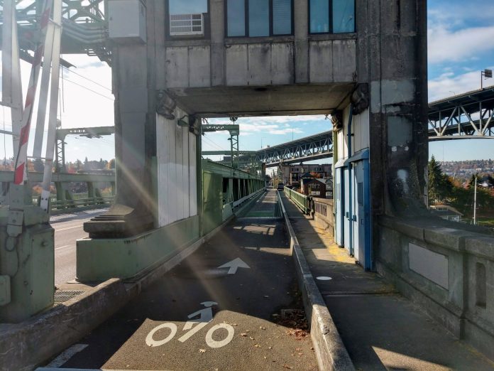 The southbound bike lane on the University Bridge with the I-5 Bridge in the background.