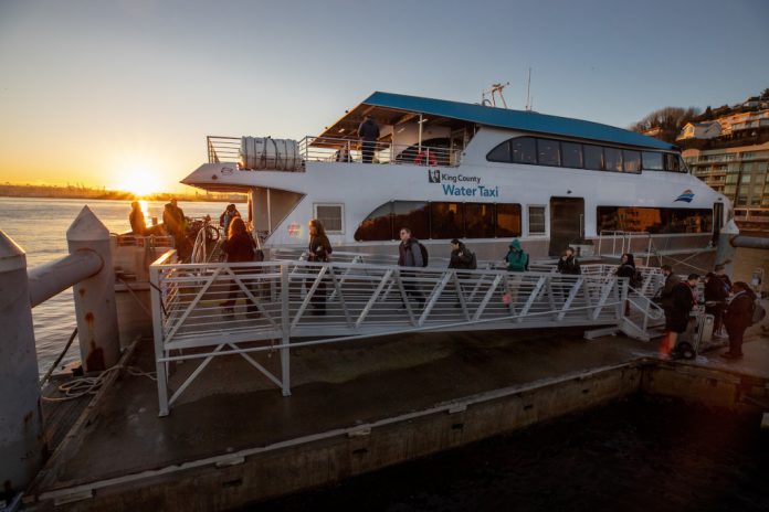 Ferry at the dock with the sunset in the background.