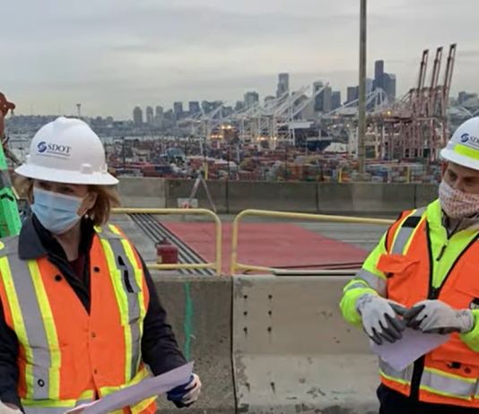 Will Electorate Blame Mayor Durkan for Four Years of Mismanagement? Mayor Durkan in an orange vest and SDOT hard hat at a West Seattle Bridge presser.