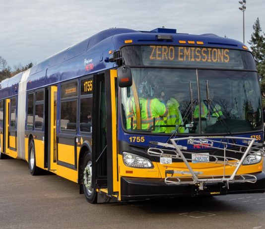 Metro’s Battery Bus Plan Hinges on Need to Grow Service and Revenue A battery-powered bus during a press event.
