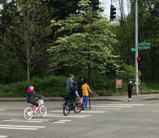 SDOT Explores Mobility Improvements Near 130th and 148th Street Light Rail Stations A family on bikes crosses a 130th Street crosswalk.