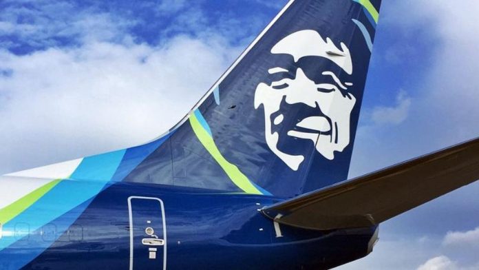 The Alaska Airline logo on the fins with the blue skies and clouds in the background.