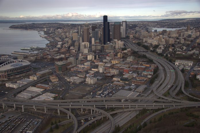 A birds eye view of Downtown Seattle from the south with the I-5 and I-90 spaghetti interchange dominating the frame.