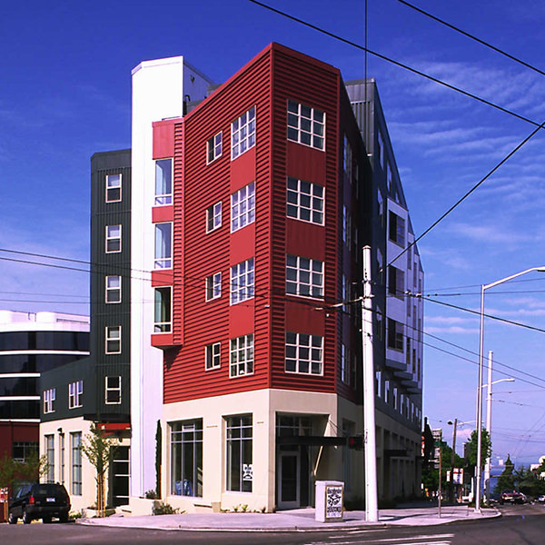 A five story building with red siding.