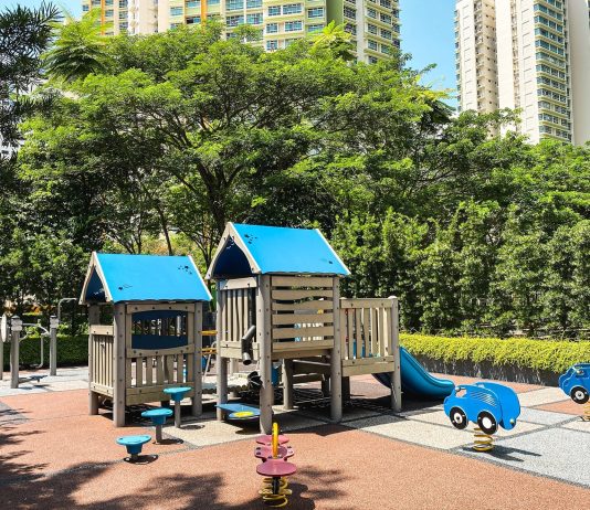 Social Housing Skeptics Are Full of It A playground with trees and public housing towers in the background