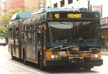 Mayor Durkan Proposes $23.7 Million in Transit Investments with I-976 Defeated A green and yellow Route 40 with Fremont displayed on its screen with downtown towers in background.