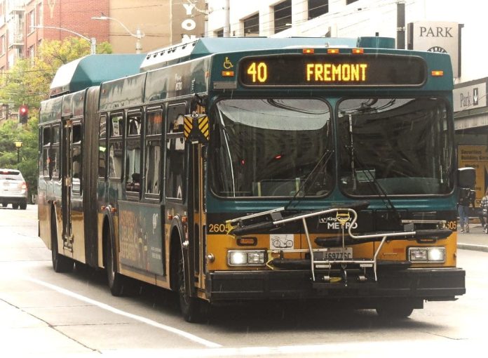 A green and yellow Route 40 with Fremont displayed on its screen with downtown towers in background.